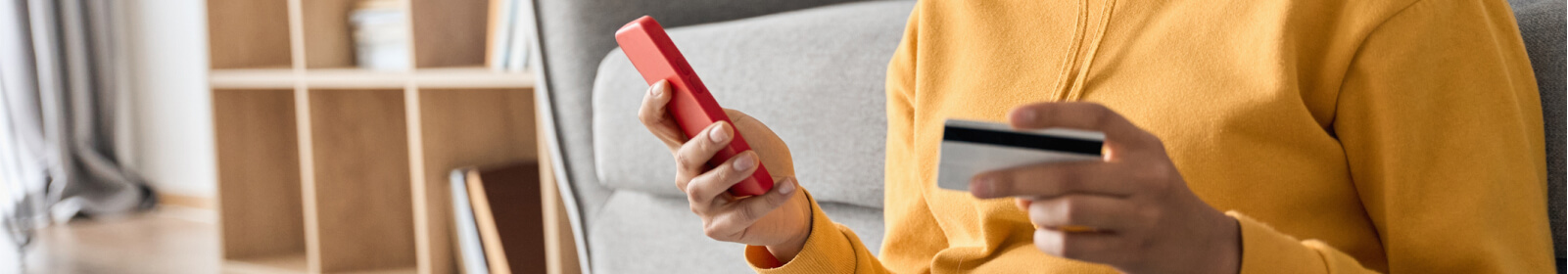 Woman holding a credit card and smartphone