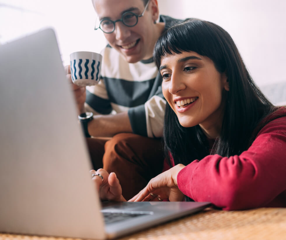 Man and woman looking at a laptop